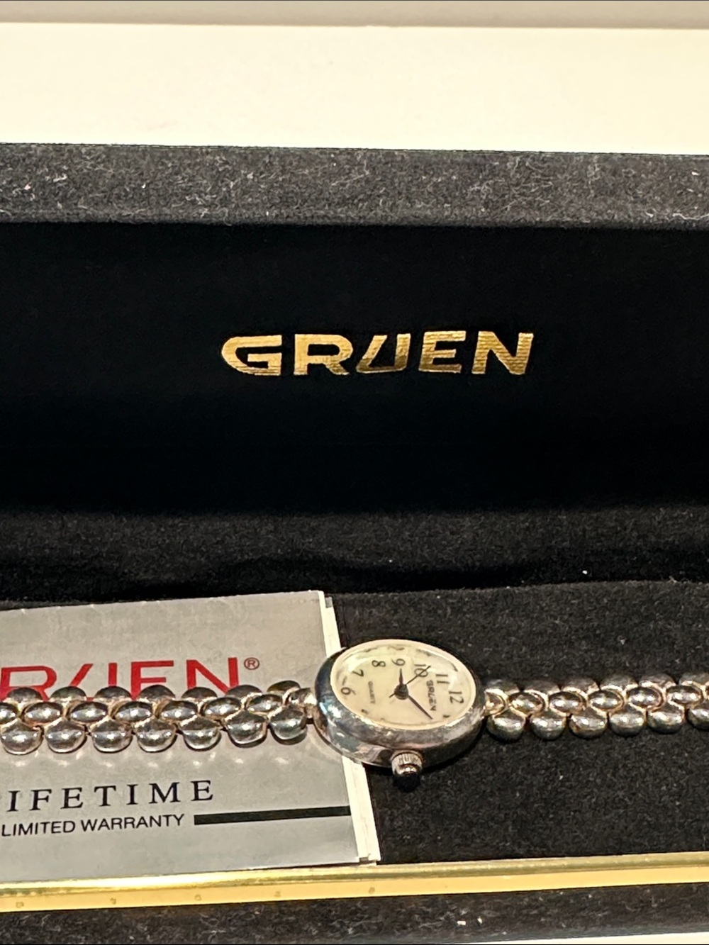 Vintage Gruen Quartz Watch with Silvertone Case and Stainless Steel Back.